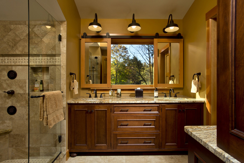 Sliding mirrors provide privacy or view as desired in this modern cabin bathroom design by Saratoga Springs, NY, custom builder Teakwood Builders.