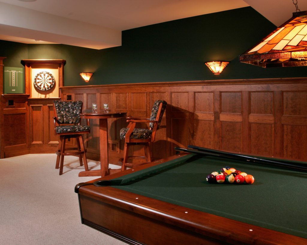 Cherry judge’s paneling gives this basement turned “pub” a rich, manly feel.