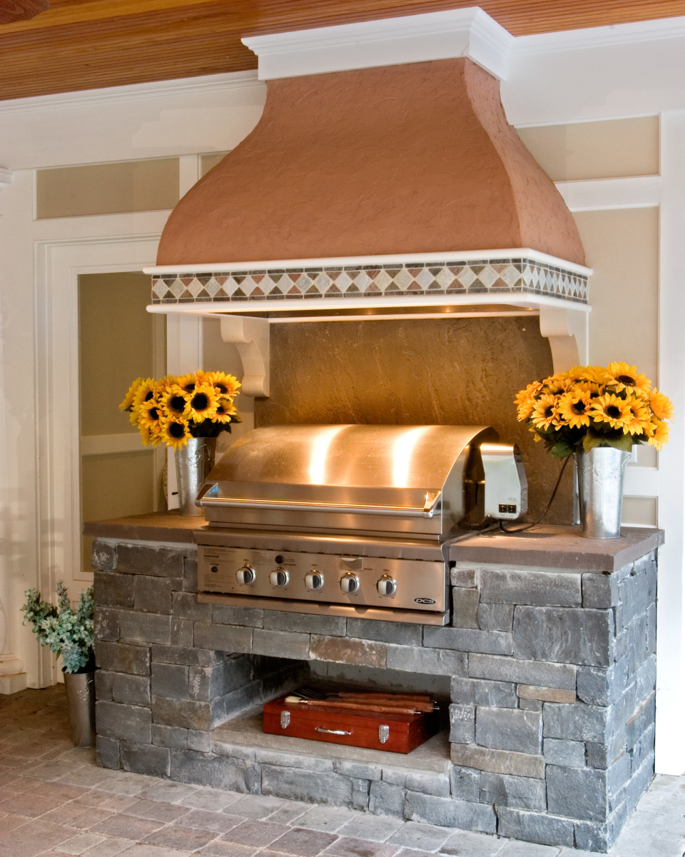 ven the barbecue pit can benefit from a beautiful chapeau like this terra cotta and tile creation. The hood adds color and dignity to the patio and draws smoke away from the comfortable lounging space. By Teakwood Builders, kitchen and bath remodeler, custom home builder and general contractor Saratoga Springs and Capital Region.