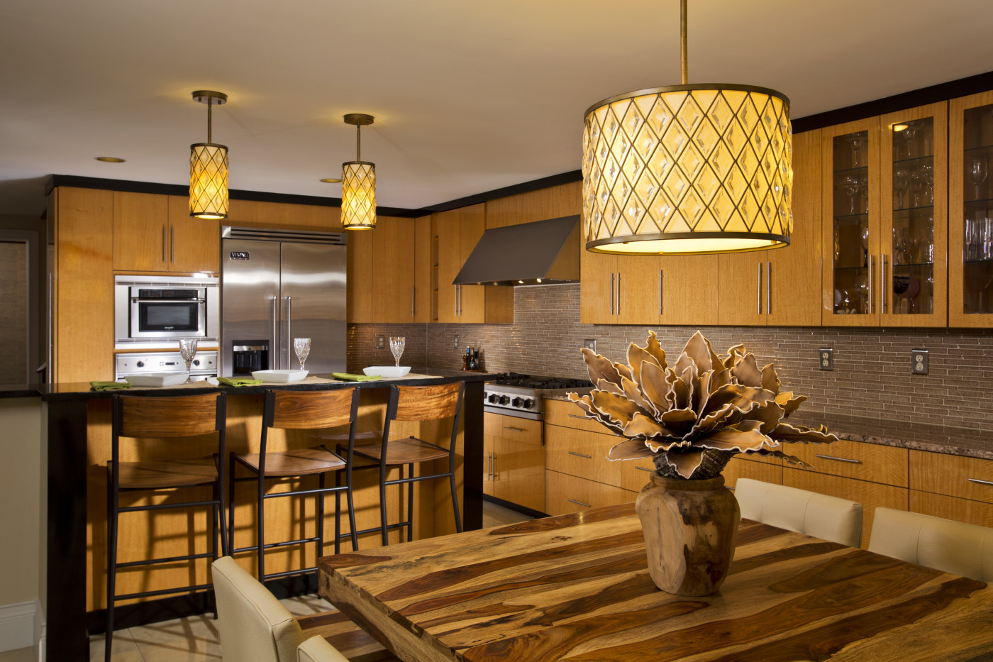 A canopy "professional" style range hood is a subtle choice that serves well when the focal point of the kitchen is lighting or striking furnishings. Teakwood Builders, kitchen and bath remodeler, custom home builder and general contractor Saratoga Springs and Capital Region.